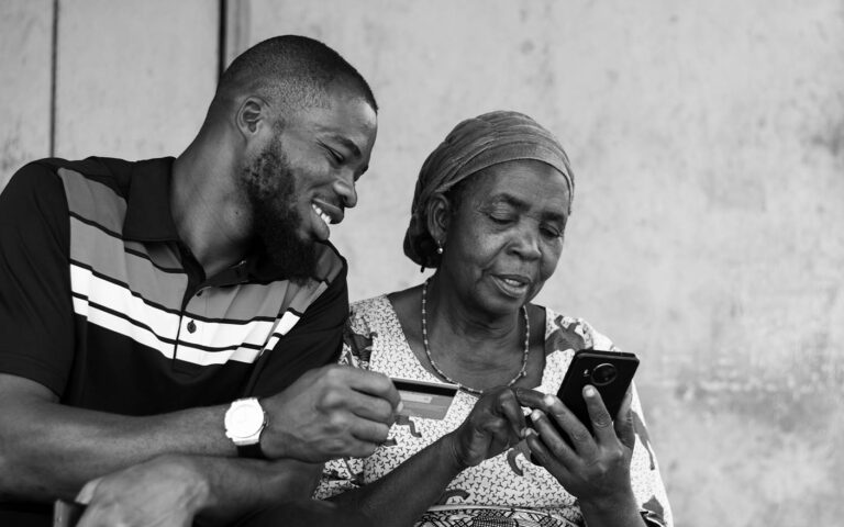 african-woman-and-man-looking-at smart-phone