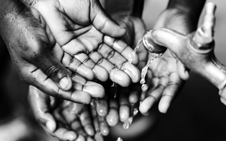 hands-of-african-children-under-water-faucet